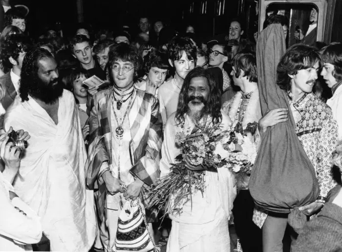 Framed Print : The Beatles with the Maharishi Mahesh Yogi who is clutching bundles of flowers Beatles