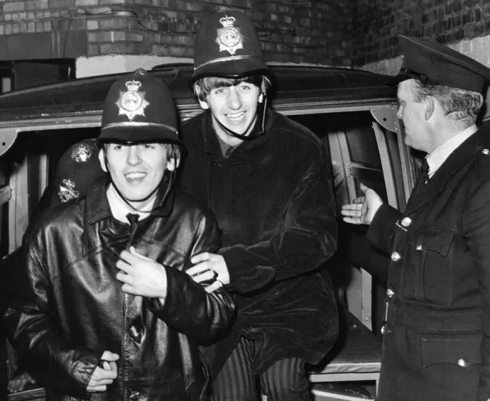 Framed Print : The Beatles members George Harrison and Ringo Starr clown around dressed in policemen Framed Print : The Beatles members George Harrison and Ringo Starr clown around dressed in policemen