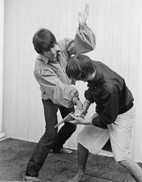 Framed Print : Beatles members George Harrison and Ringo Starr engage stage mock combat at the rented Framed Print : Beatles members George Harrison and Ringo Starr engage stage mock combat at the rented