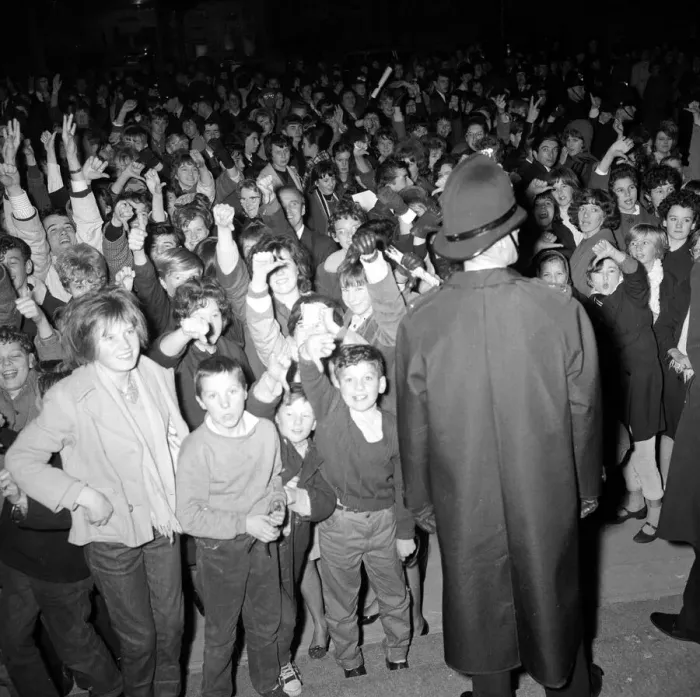 Framed Print : The Beatles November 1963 A policeman stands guard as fans of The Beatles cheer Framed Print : The Beatles November 1963 A policeman stands guard as fans of The Beatles cheer