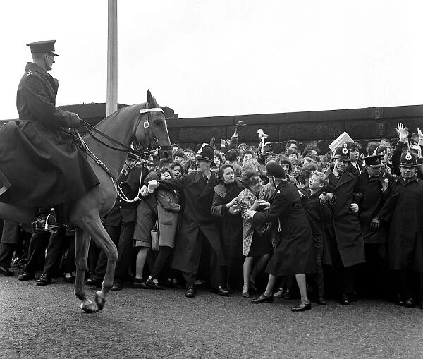 The Beatles November 1963 Policemen and women help to push the teenagers back
