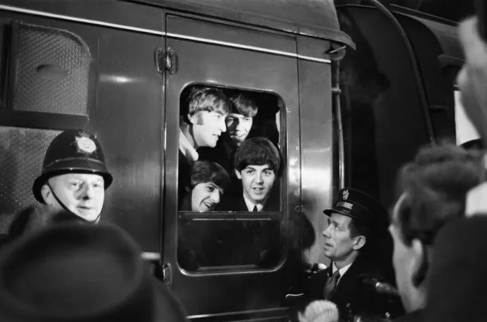 Framed Print : The Beatles peer from a train carriage window at Paddington Station, London Framed Print : The Beatles peer from a train carriage window at Paddington Station, London