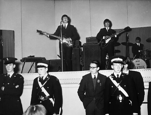 The Beatles performing on stage at De Montford Hall in Leicester, 11th October 1964