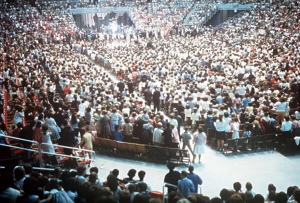 The Beatles play to a packed out Seattle Center during their second tour of the USA