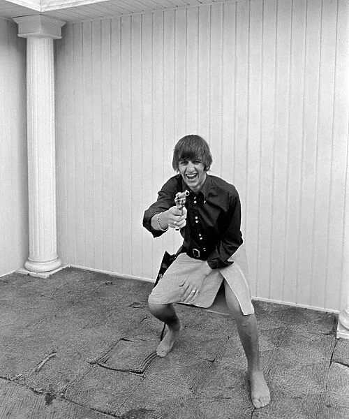 Beatles at pool in a private home in Los Angeles. Ringo Starr playing cowboy at Beatles