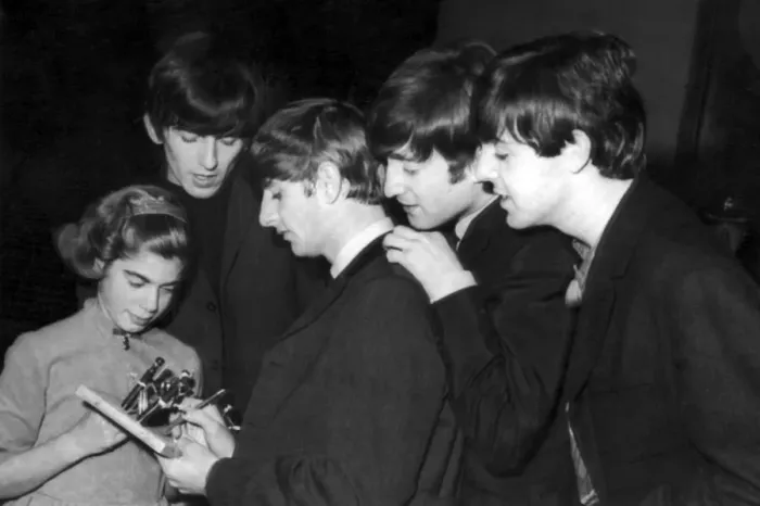 Framed Print : The Beatles sign autographs for a young fan after concert at the Odeon in Southend-on-Sea