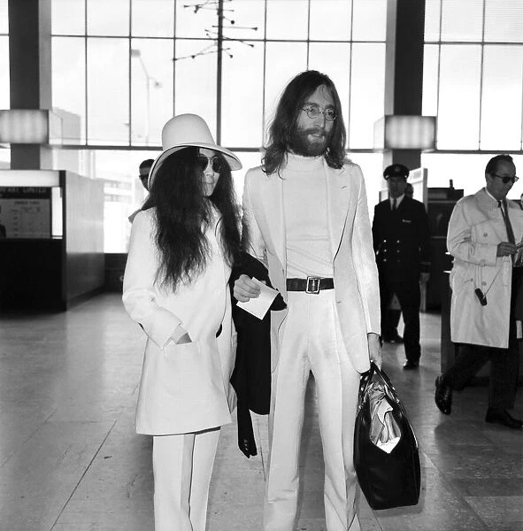 Beatles singer songwriter John Lennon and wife Yoko Ono pictured at Heathrow today