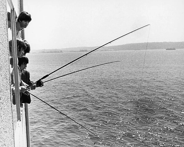 The Beatles do a spot of fishing from their hotl room in Seattle Washington 22nd August