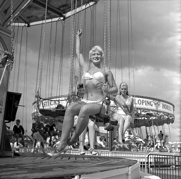 Beauty contest girls at Clacton Butlins on a fairground ride. 19th July 1959