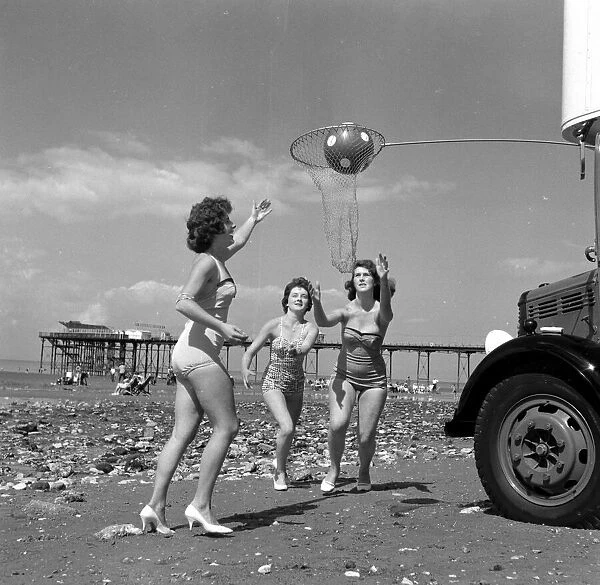Beauty contest girls playing netball at Hunstanton, UK. 25th August 1959
