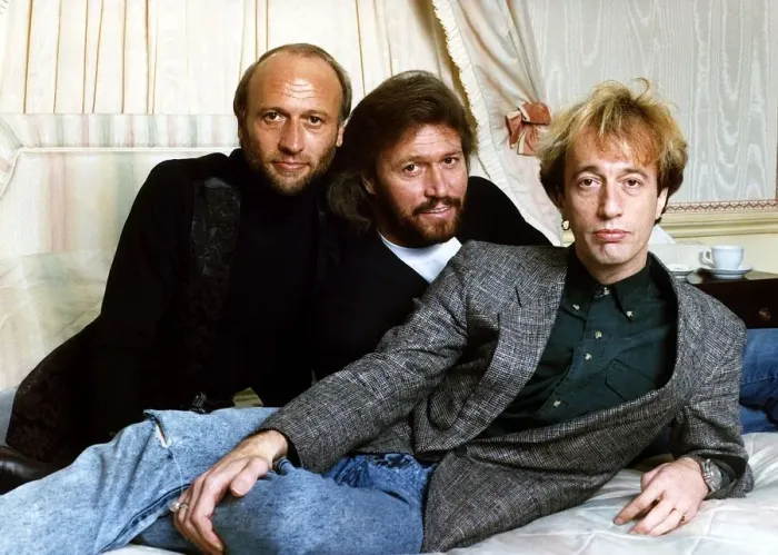 Framed Print : Bee Gees Pop Group brothers Maurice Gibb Barry Gibb & Robin Gibb together relax before