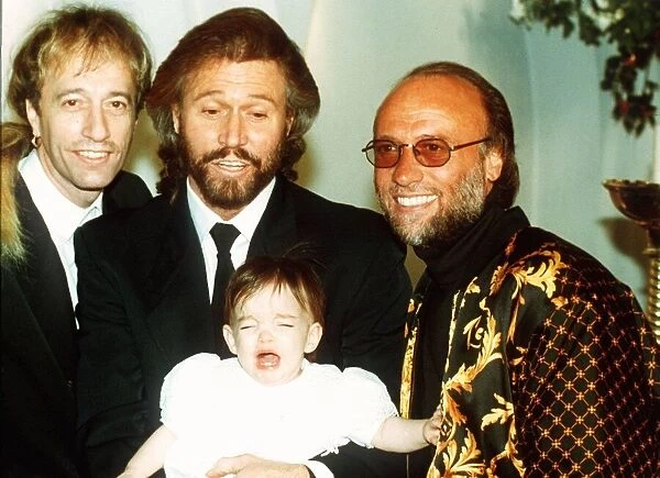 Bee Gees pop group Maurice Gibb Robin Gibb and Barry Gibb with his baby daughter