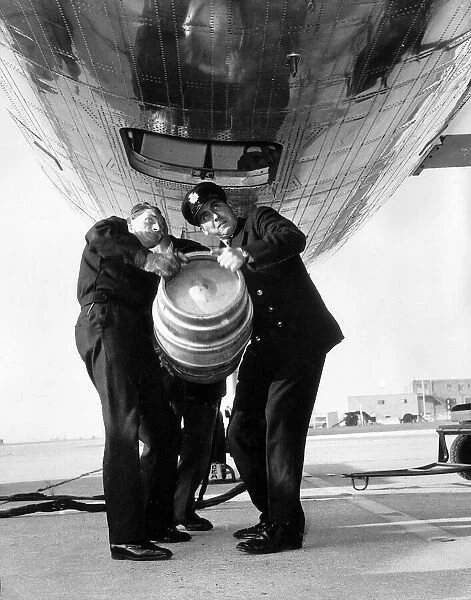A beer barrel is loaded into the cargo hold of a De Havilland Comet at London Airport
