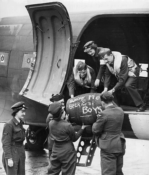 Beer being loaded onto a plane for the troops in France. August 1944
