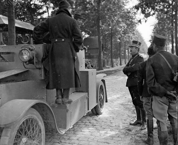 Belgian officers talk to the crew of an armoured car during a lull in the fighting in