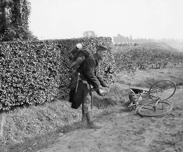 A Belgian soldier captures a rabbit for the pot. September 1914