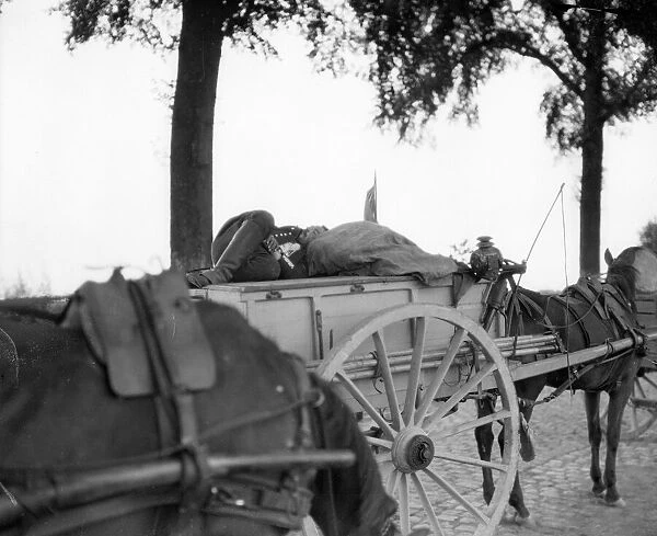 A Belgian soldier grabs a few moments rest in a cart. Circa August 19th 1914