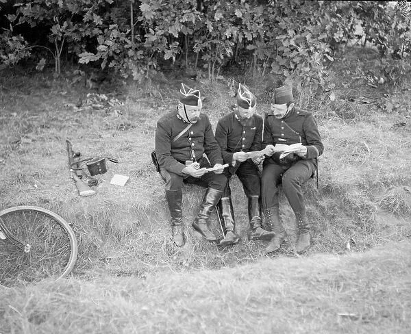 Belgian soldiers consort their maps as the German army advances through Belgium