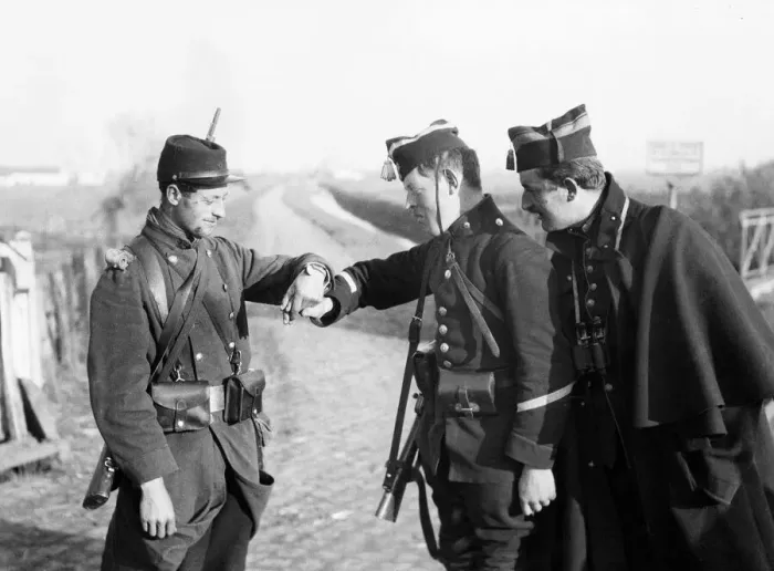 Framed Print : Belgian soldiers reading the identification disc which this French soldier has placed Framed Print : Belgian soldiers reading the identification disc which this French soldier has placed