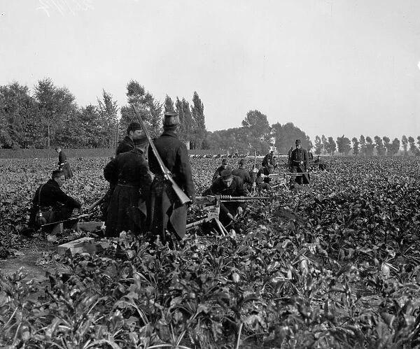 Belgian soldiers seen here digging in and setting up machine guns before the Battle of