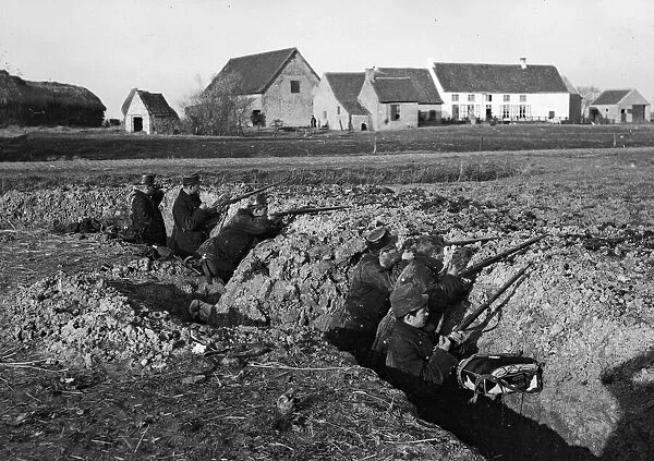 Belgian soldiers seen here in a hastily constructed trench close to Diksmuide during