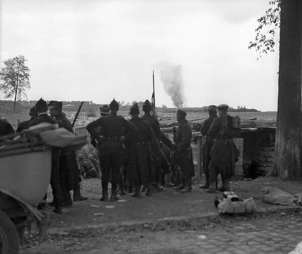 Belgian soldiers at Vieux Wien near Antwerp watch the advancing Germans shelling their