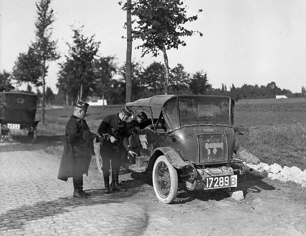 Belgium officers inspect a staff car which had been captured by the Germans along with