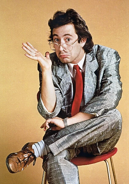 Ben Elton comedian sitting hunched over A©mirrorpix