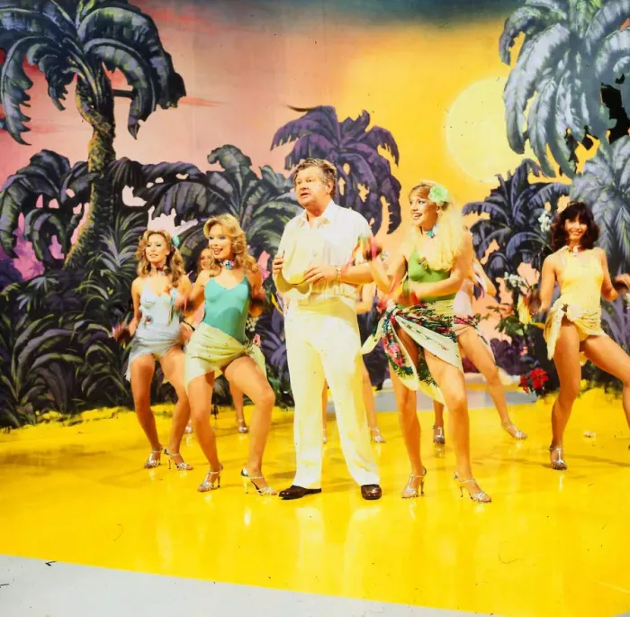 Framed Print : Benny Hill comedian 1989 With girls dancing on stage desert island palms trees set