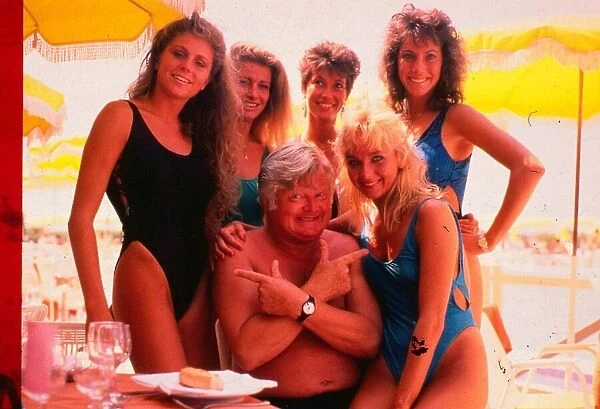 Benny Hill comedian June 1992 With girls on beach pointing fingers