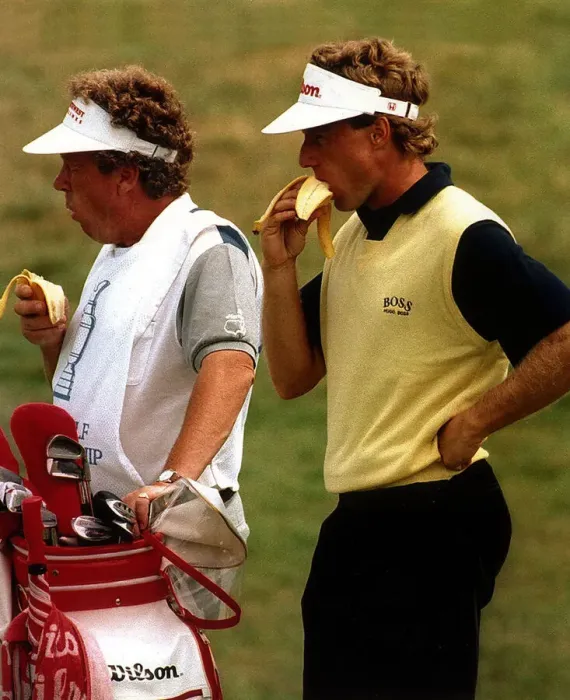 Framed Print : Berhard Langer Golf and his caddy take a break and eat a banana during a golf
