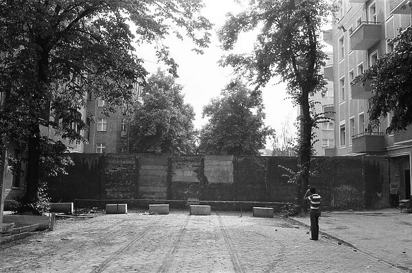 The Berlin Wall. The wall running into houses on either side of the road