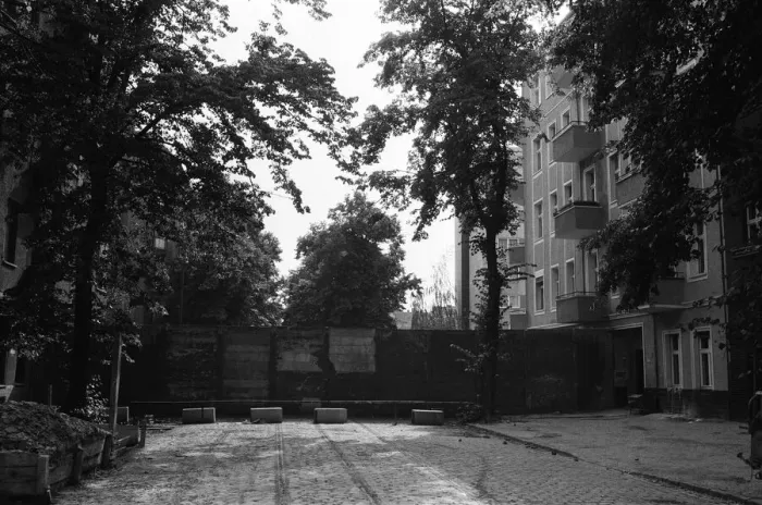 Framed Print : The Berlin Wall. The wall running into houses on either side of the road Framed Print : The Berlin Wall. The wall running into houses on either side of the road