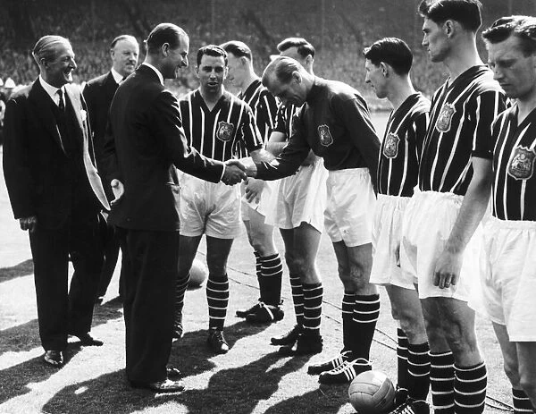 Bert Trautmann of Manchester shakes hands with Prince Philip before the 1956 FA Cup