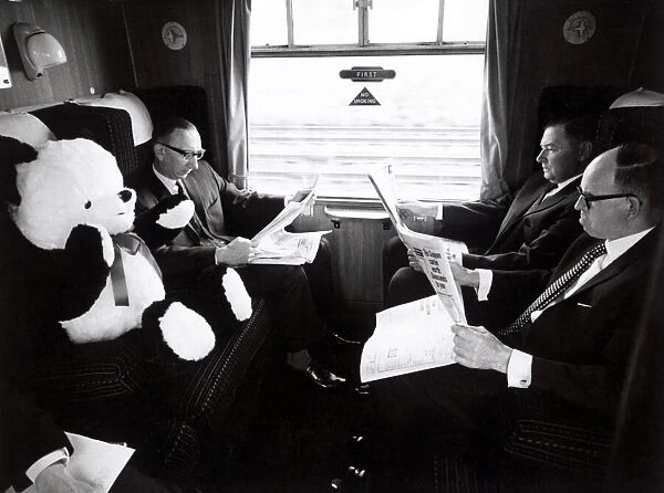 In best British fashion, fellow passengers ignore Peter the panda in a carriage on board
