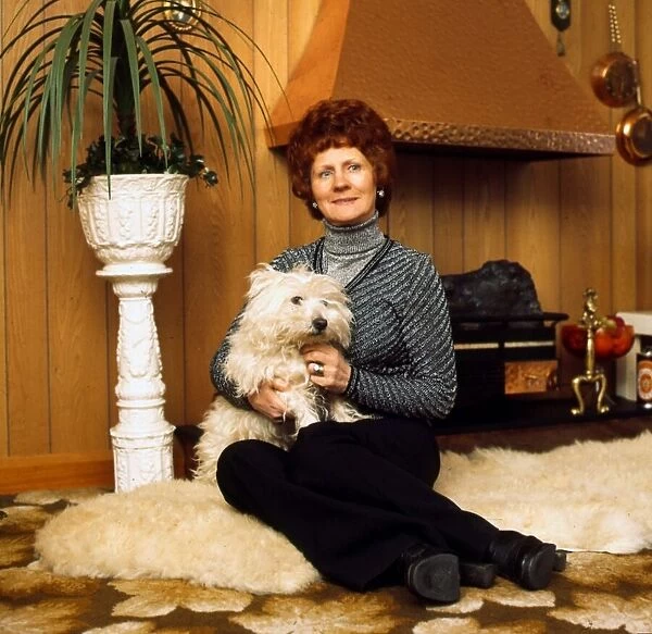 Betty Lawrie at home holding dog March 1975