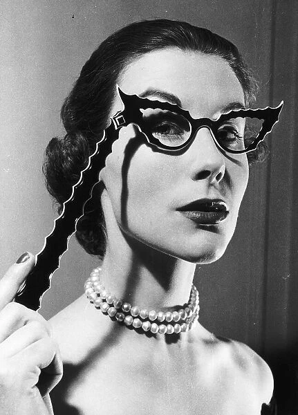 Betty Spurling who puts on TV fashion shows designs glasses February 1953