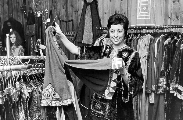 Betty Van Gelder, owner of a dress shop in Hampstead, wearing one of her own velvet