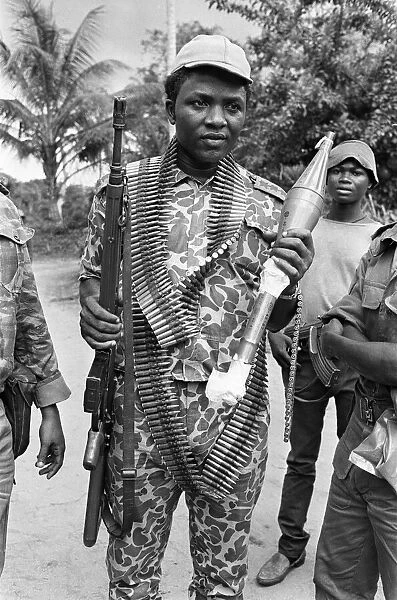 A Biafran soldier seen here holding an AK-47 assault rifle in one hand