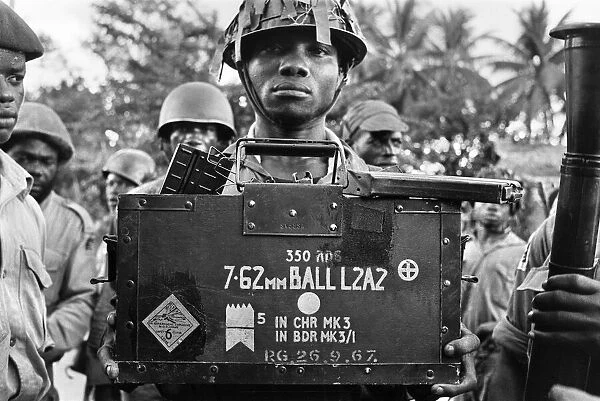 A Biafran soldier seen here holding a box of explosives during the Biafran conflict