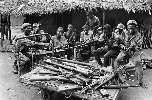 Biafran soldiers seen here testing out a large stockpile of weapons during the conflict