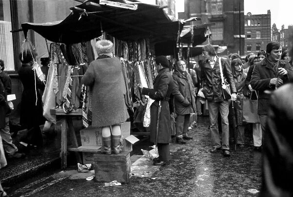 Last of the big spenders at Petticoat Lane. This lady stall holder uses a box to keep up