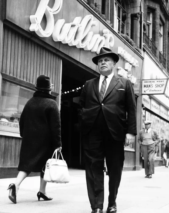 Framed Print : Billy Butlin walking past one of his Butlins shop on the high street. Dbase Framed Print : Billy Butlin walking past one of his Butlins shop on the high street. Dbase