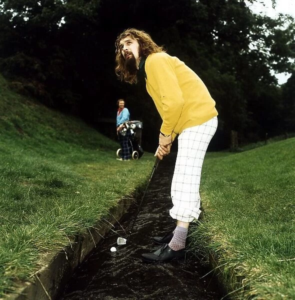 Billy Connolly golf 1974 in stream playing shot trousers rolled up
