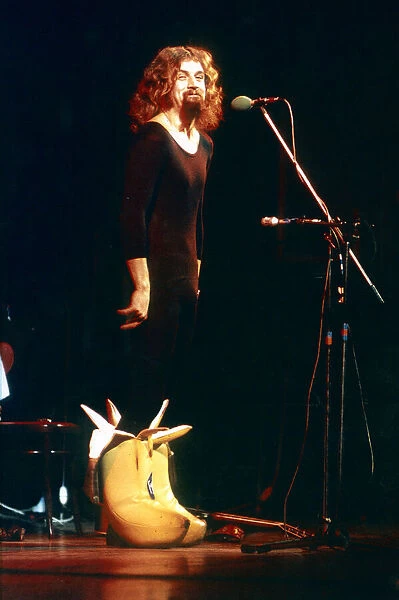 Billy Connolly on stage wearing big banana boots