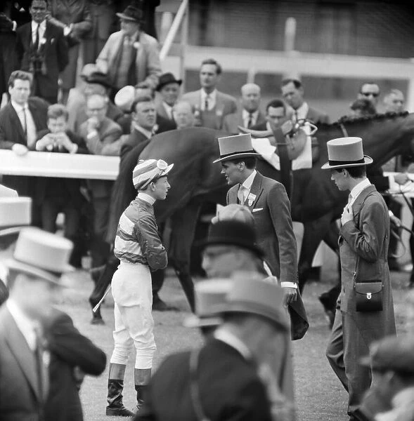 Billy Fury talking to his jockey, on Derby Day at the Epsom Races. 3rd June 1964