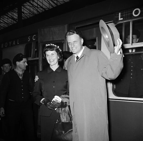 Billy Graham, the evangelist, arrived in London tonight with his wife Ruth after his
