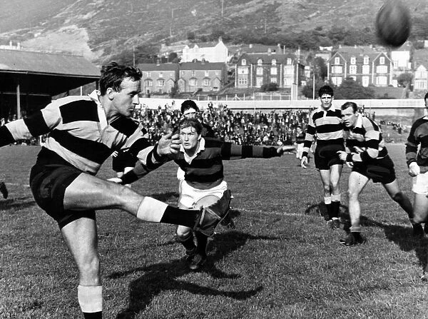 Billy Hullin, Cardiff Rugby Union Player, clears before John Davies of Aberavon can close
