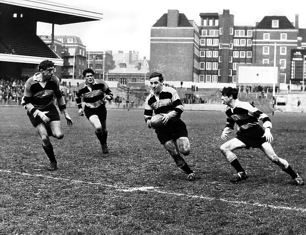 Billy Hullin, Cardiff Rugby Union scrum half, breaks with the ball as Newport forward