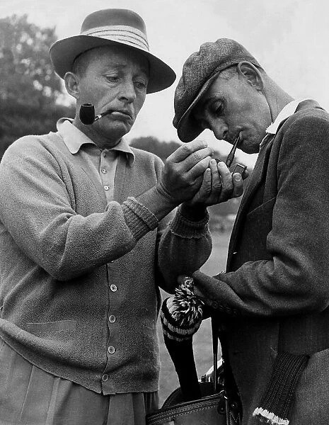 Bing Crosby and caddie break for a smoke during a round of golf, September 1952